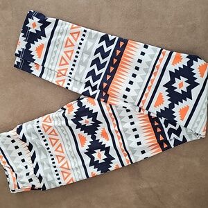 LuLaRoe Tween Kids Leggings with Geometric Pattern in Orange, Black, and White